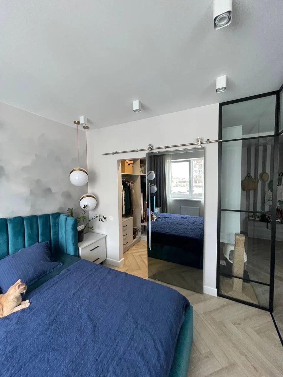 Bedroom with a sliding mirrored door to the wardrobe