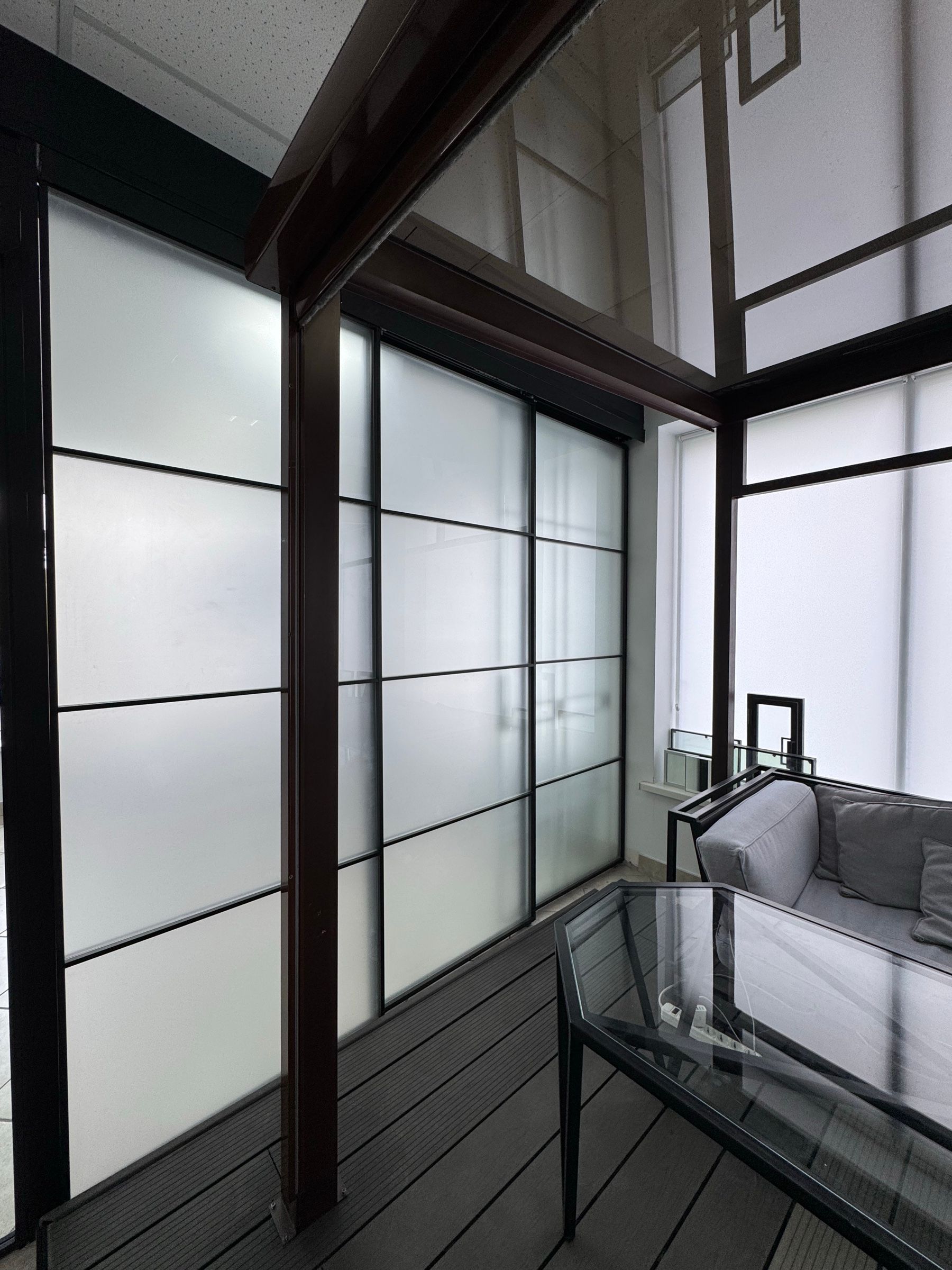 Office partition with frosted white glass and a grid layout