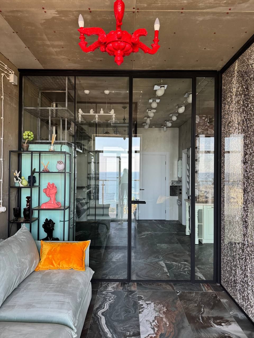 Black-framed glass partition with textured cracked-ice glass in a living room