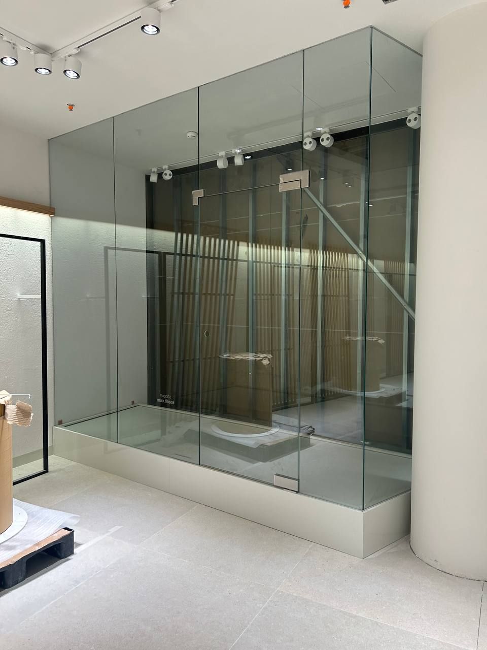 Glass showcase on a podium in a shop interior